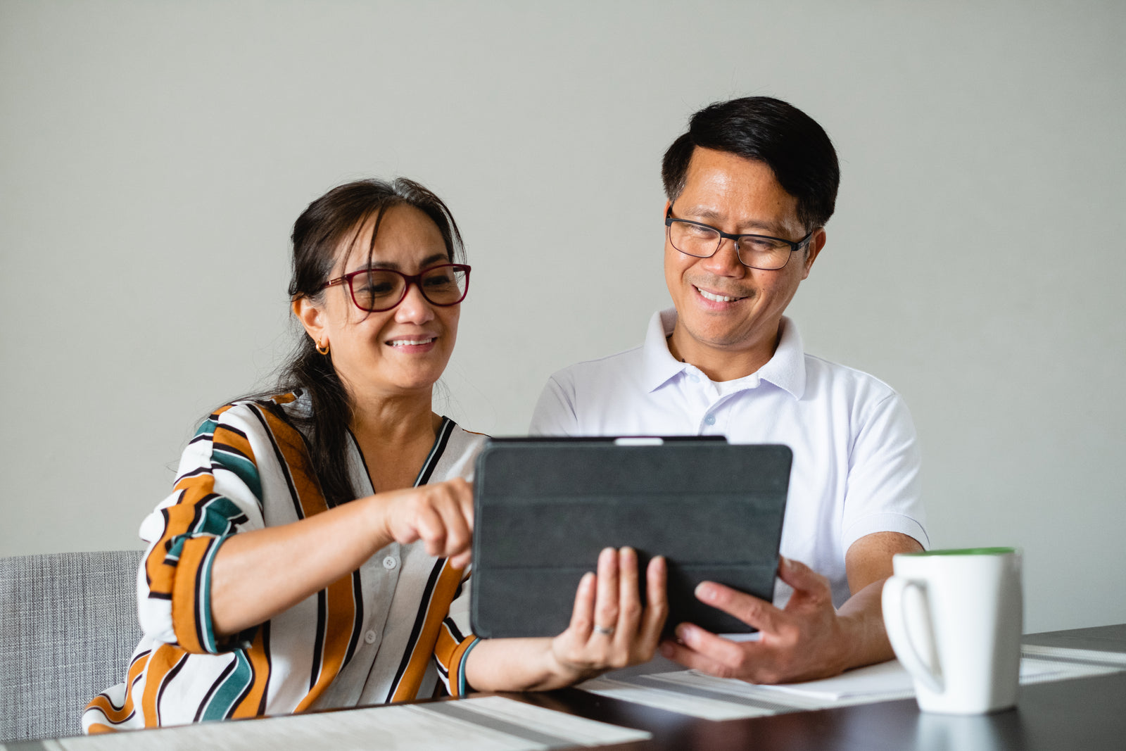 A couple looking at a tablet together at home