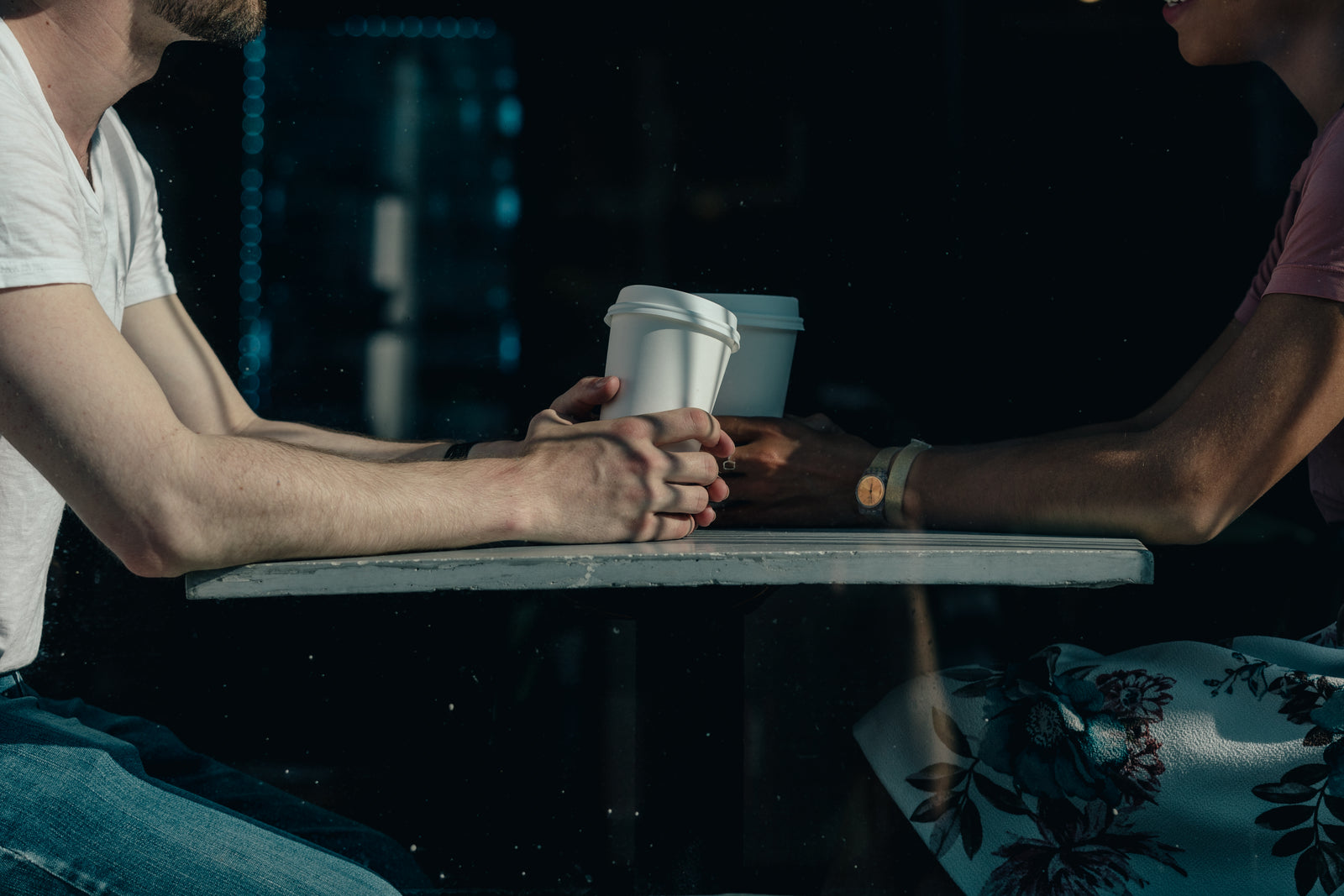 Two people talking over coffee at a table